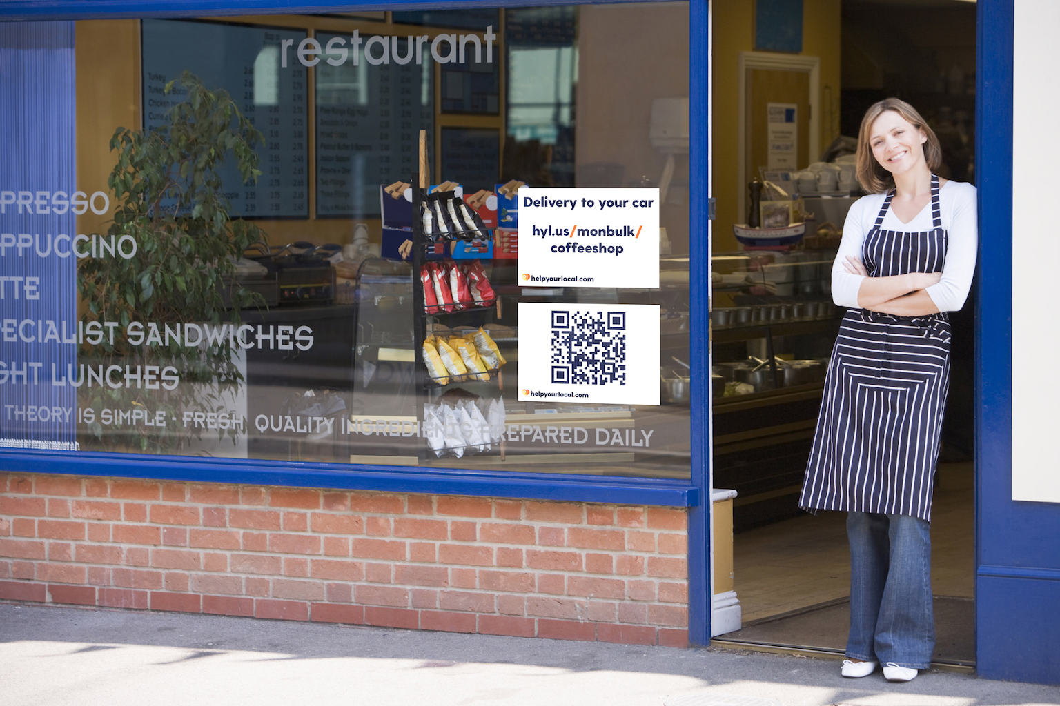 A shopkeeper in the doorway of her shop.