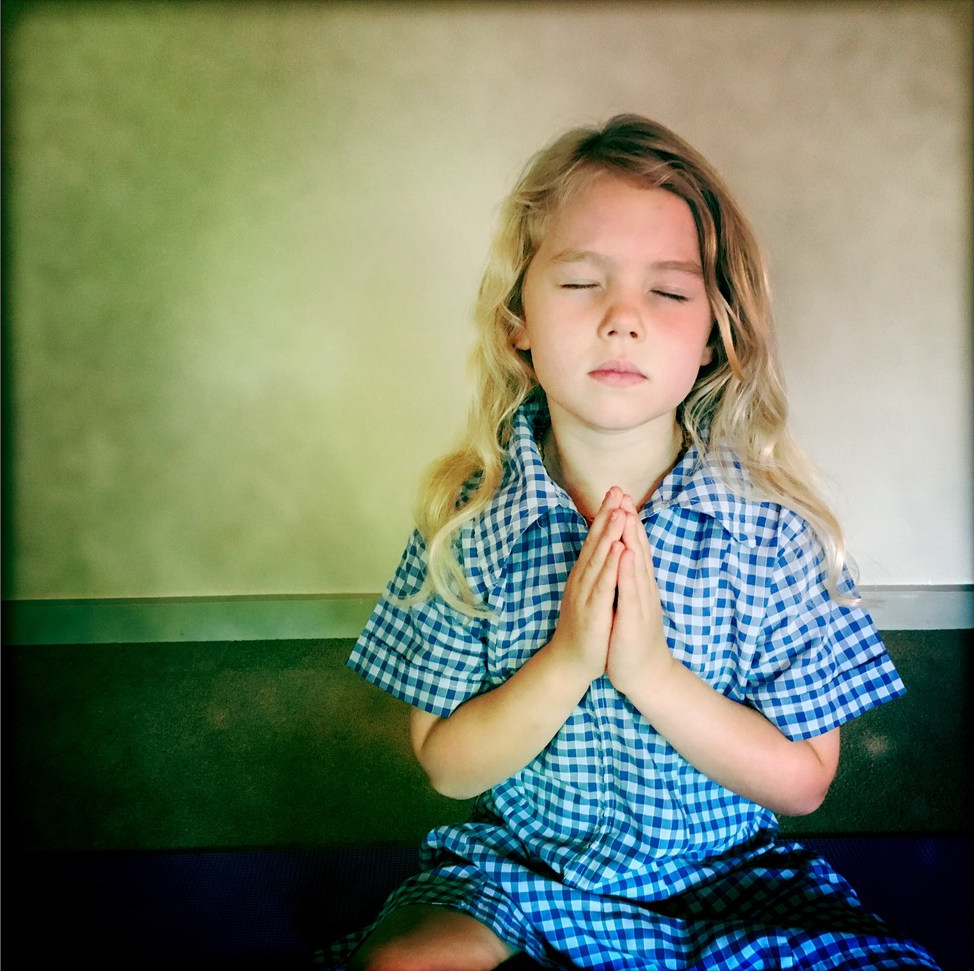 An image of a child practicing yoga